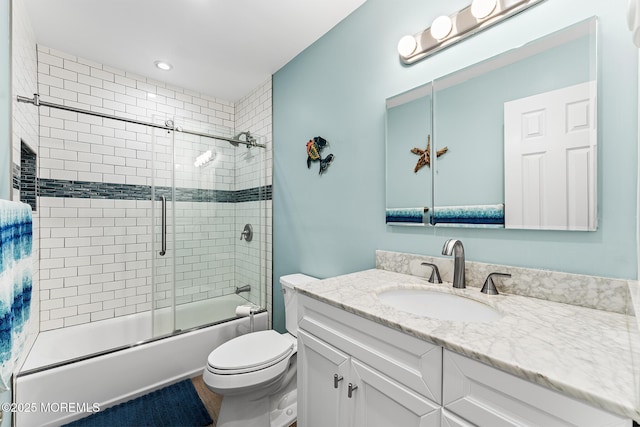 full bathroom featuring enclosed tub / shower combo, toilet, and vanity