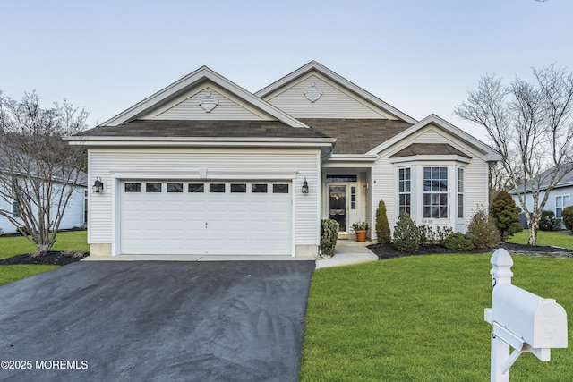 view of front facade with a garage and a front yard