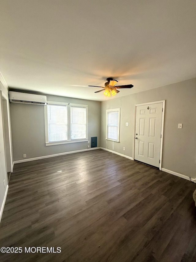 interior space with ceiling fan, a wall mounted air conditioner, and dark hardwood / wood-style flooring