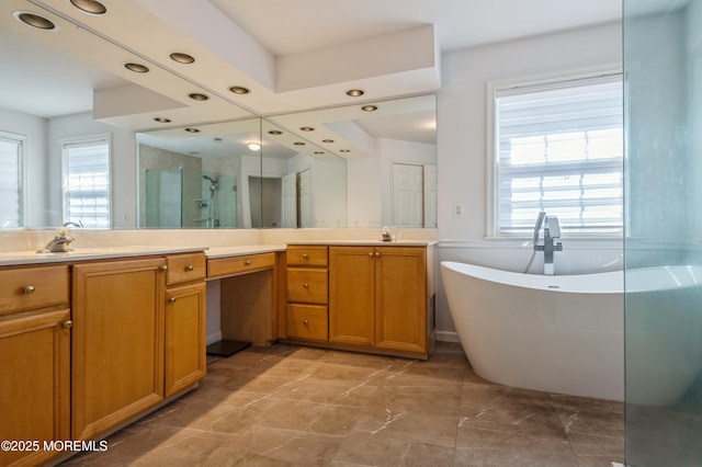 full bathroom featuring a stall shower, recessed lighting, a freestanding bath, and vanity