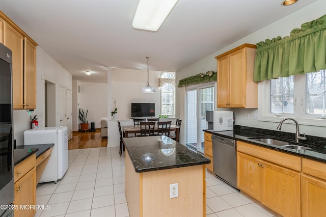 kitchen with light tile patterned floors, a kitchen island, open floor plan, a sink, and stainless steel dishwasher