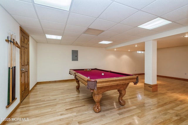 game room featuring a paneled ceiling, pool table, light wood-style flooring, electric panel, and baseboards