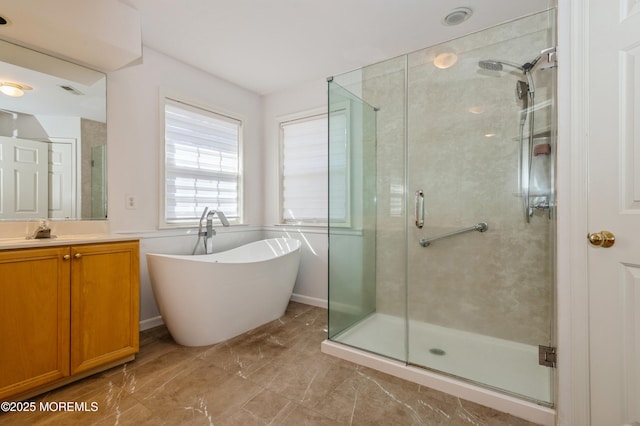 bathroom with a soaking tub, a shower stall, and vanity