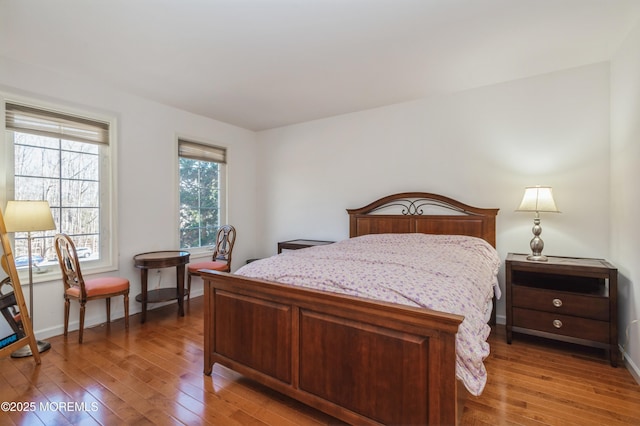 bedroom featuring baseboards and hardwood / wood-style floors