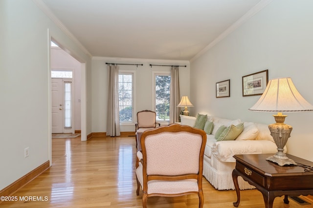 sitting room featuring visible vents, ornamental molding, light wood-style flooring, and baseboards