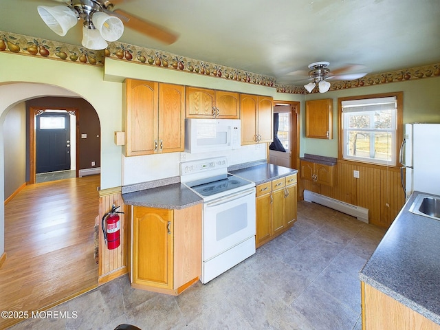 kitchen featuring white appliances, ceiling fan, and a baseboard radiator