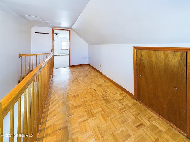 bonus room with ceiling fan, light parquet floors, and vaulted ceiling