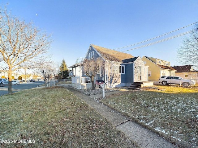 view of side of home with a yard