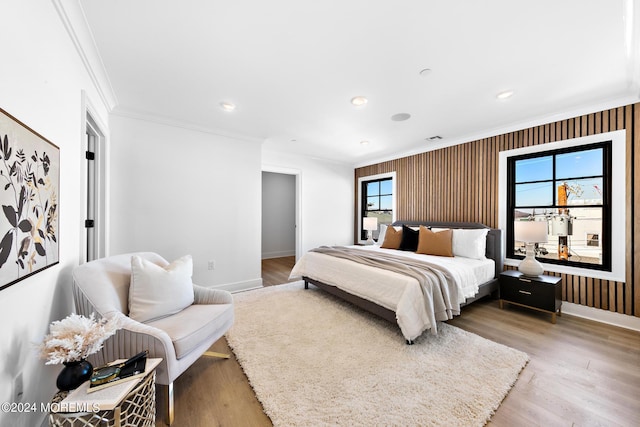 bedroom with light wood-type flooring and ornamental molding