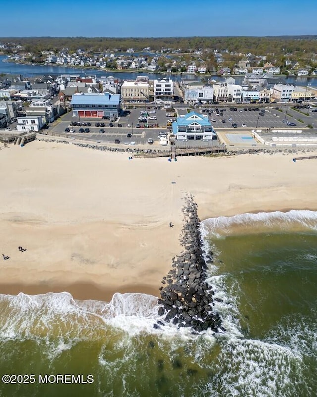 aerial view featuring a view of the beach and a water view