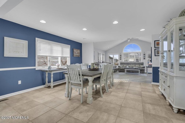 tiled dining room with ceiling fan and lofted ceiling