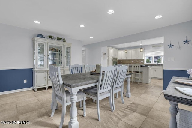 tiled dining room featuring sink