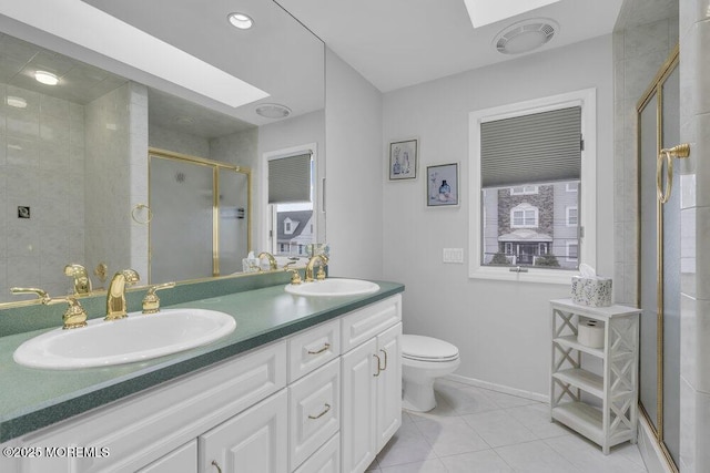 bathroom with an enclosed shower, vanity, and a skylight