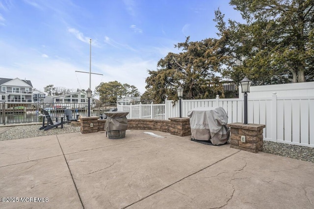 view of patio / terrace featuring an outdoor fire pit and grilling area