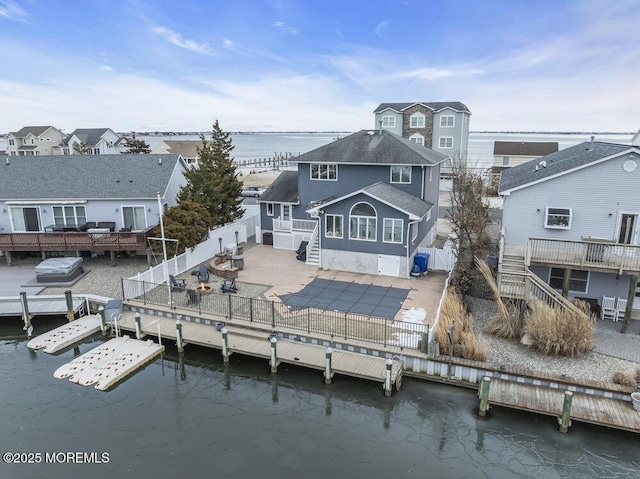 back of house with a patio area and a deck with water view