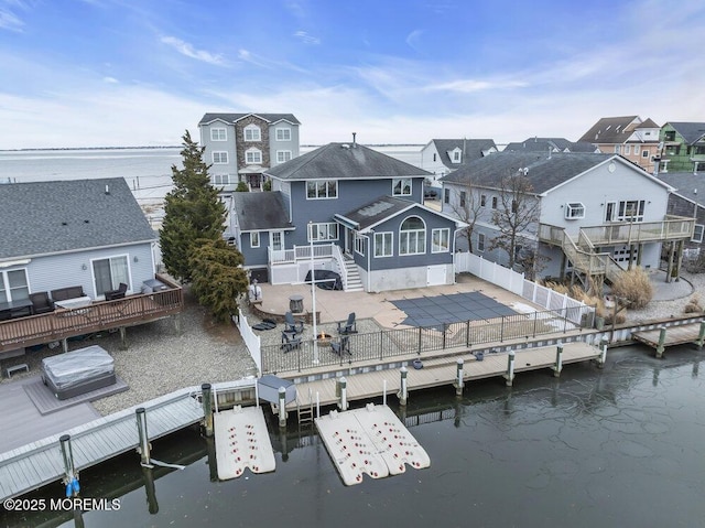 rear view of property featuring a water view and a patio