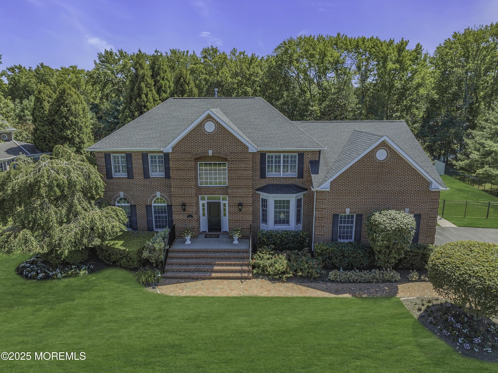 colonial home with a front yard