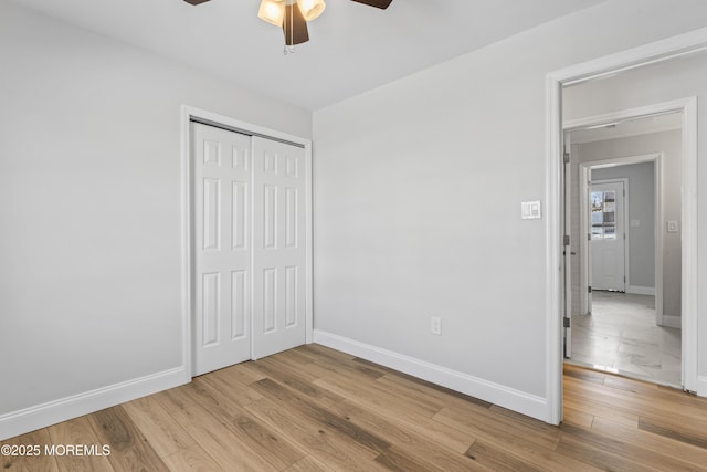 unfurnished bedroom featuring a closet, light hardwood / wood-style floors, and ceiling fan