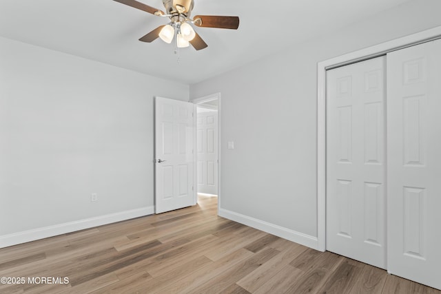 unfurnished bedroom with ceiling fan, a closet, and light hardwood / wood-style flooring