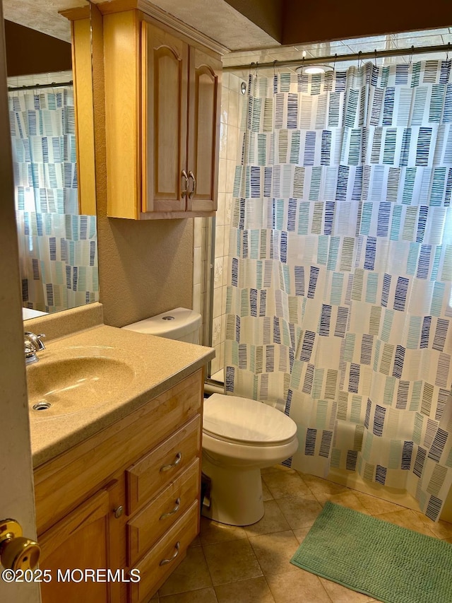 full bathroom with toilet, tile patterned flooring, shower / tub combo, and vanity