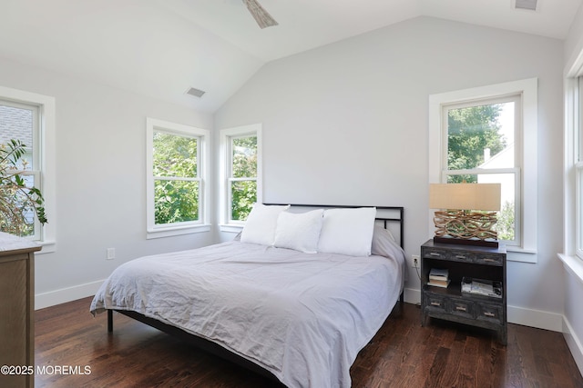 bedroom featuring lofted ceiling, dark hardwood / wood-style flooring, and ceiling fan