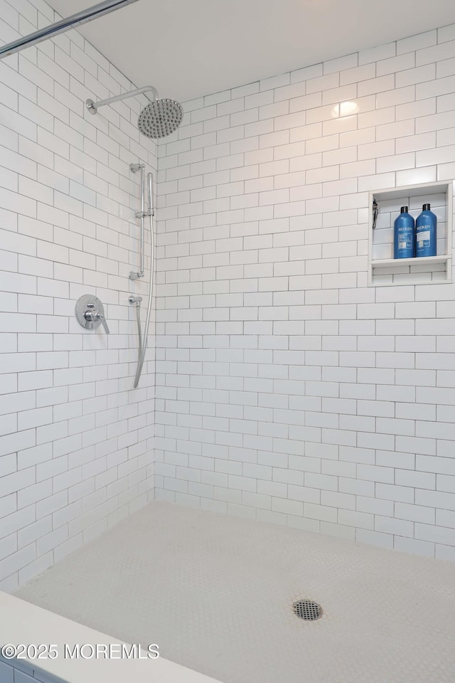 bathroom with tiled shower