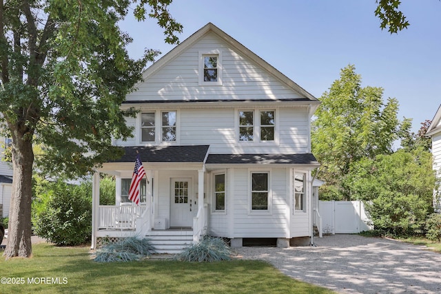 view of front of house featuring a porch and a front lawn