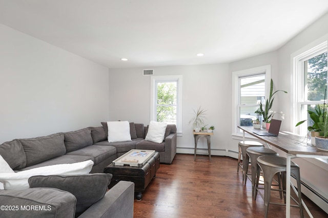 living room with baseboard heating and dark wood-type flooring