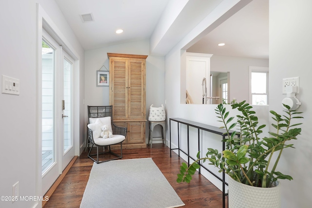 living area with dark wood-type flooring, french doors, and vaulted ceiling