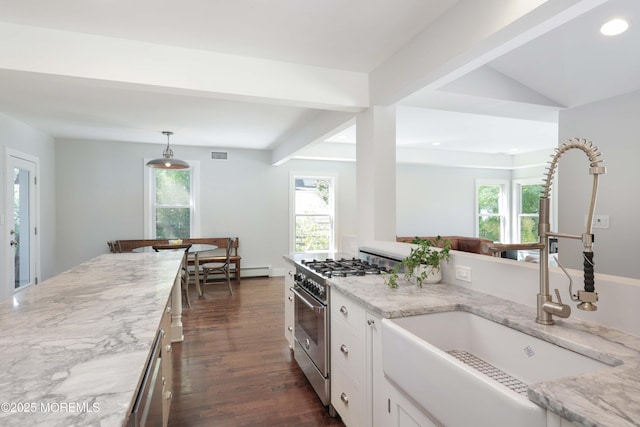 kitchen featuring light stone counters, hanging light fixtures, white cabinetry, appliances with stainless steel finishes, and sink