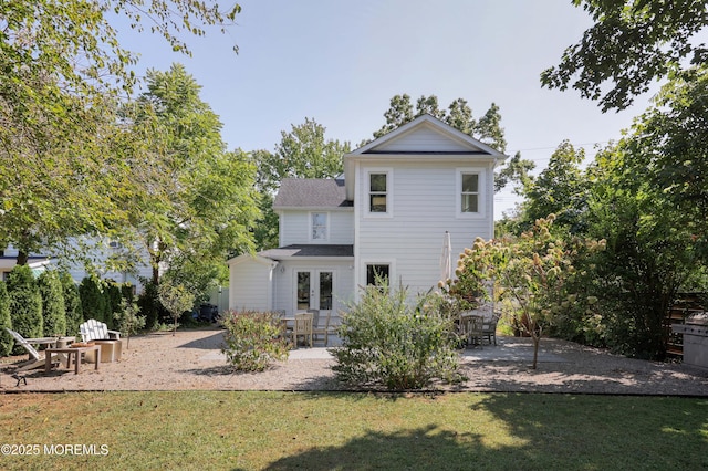 rear view of property featuring a patio area and a lawn