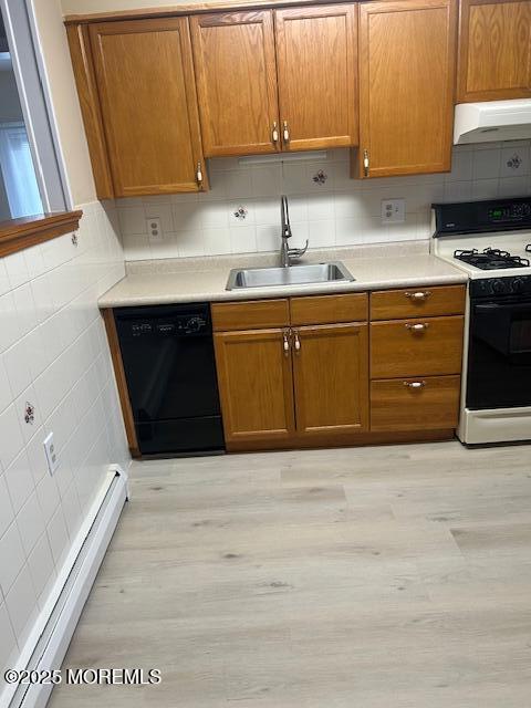 kitchen with dishwasher, light hardwood / wood-style floors, sink, gas range oven, and baseboard heating