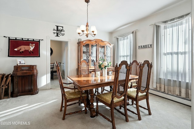 carpeted dining room with a baseboard radiator and a notable chandelier