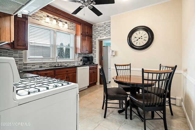 kitchen with light tile patterned floors, ceiling fan, backsplash, white appliances, and sink