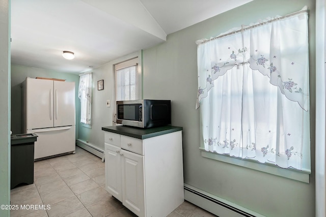 kitchen featuring white cabinets, light tile patterned flooring, white refrigerator, and a baseboard radiator