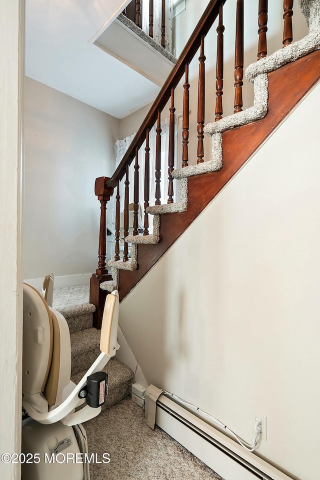 staircase featuring baseboard heating