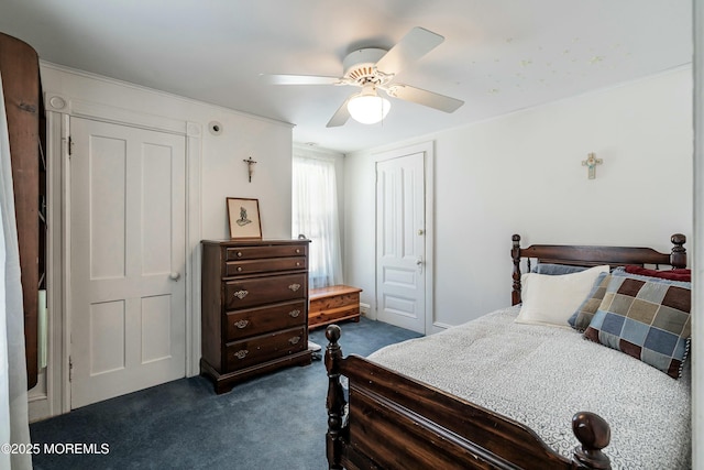 carpeted bedroom with ceiling fan and a closet