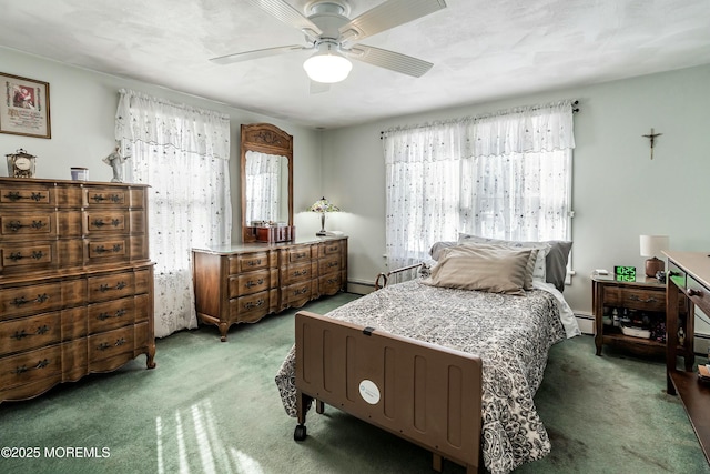 bedroom featuring ceiling fan, a baseboard heating unit, and carpet flooring