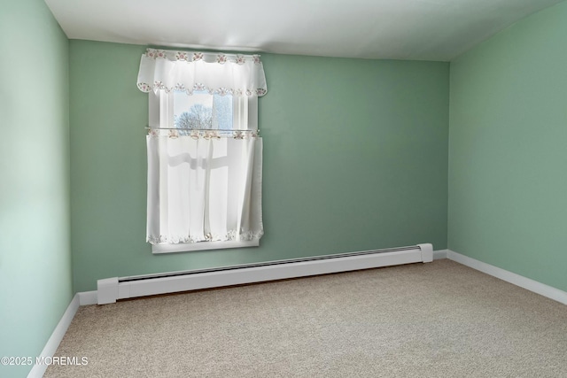 spare room with carpet flooring and a baseboard radiator