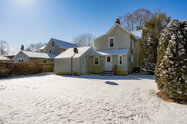 view of snow covered back of property