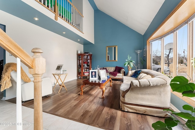 living area featuring high vaulted ceiling and wood finished floors