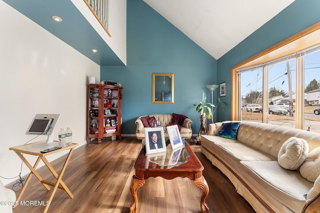 living room featuring high vaulted ceiling and wood finished floors