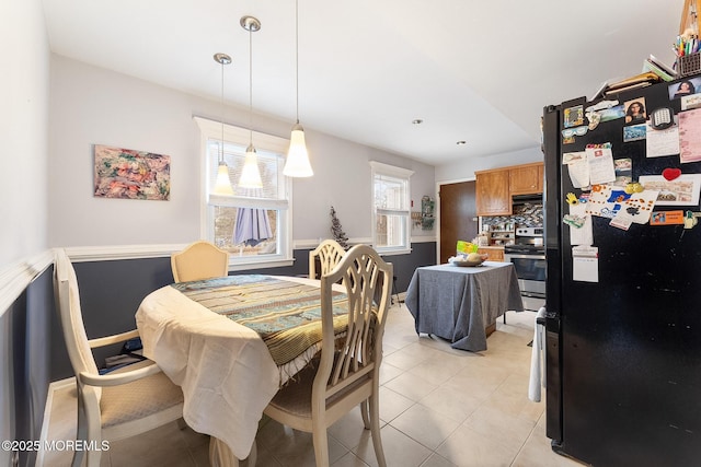 dining space featuring light tile patterned flooring