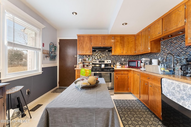 kitchen with stainless steel electric range oven, decorative backsplash, brown cabinets, and under cabinet range hood