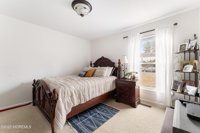 bedroom with light carpet and baseboards