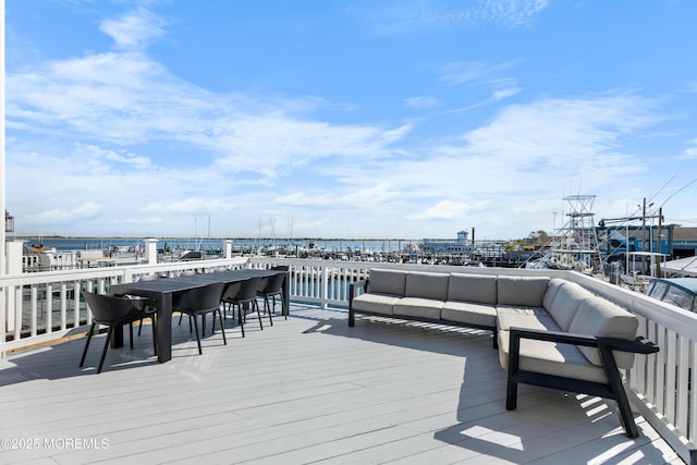 deck featuring an outdoor hangout area and a water view