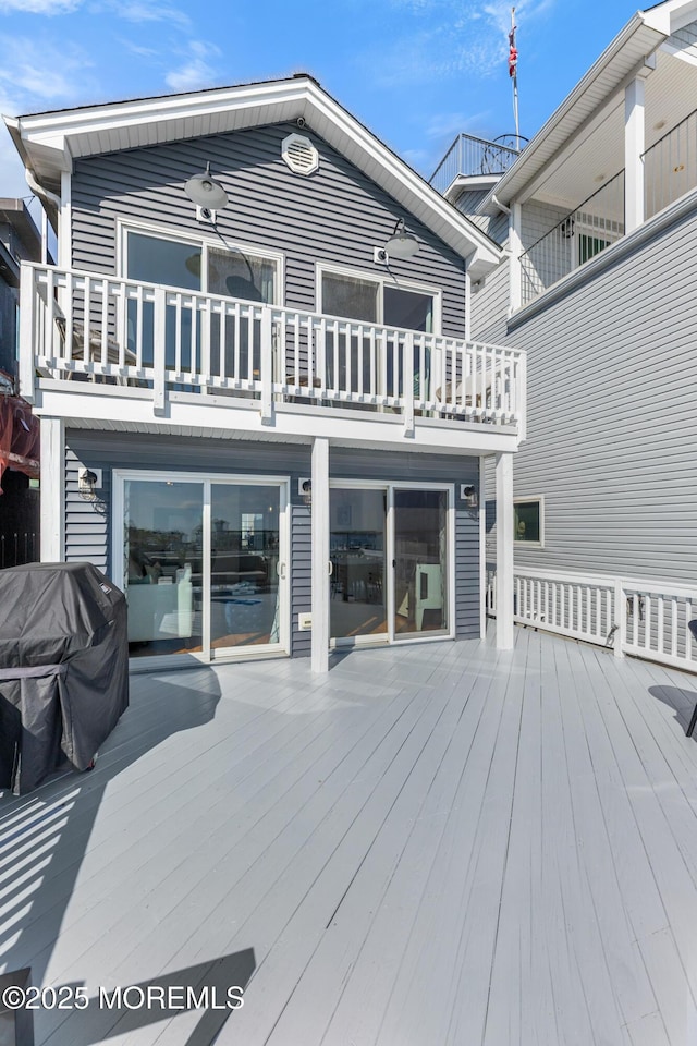 wooden deck featuring a grill