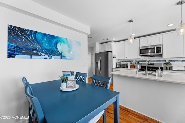 dining space featuring light wood-type flooring