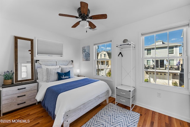 bedroom featuring ceiling fan and dark wood-type flooring