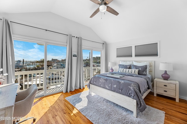 bedroom with wood-type flooring, vaulted ceiling, ceiling fan, and access to outside